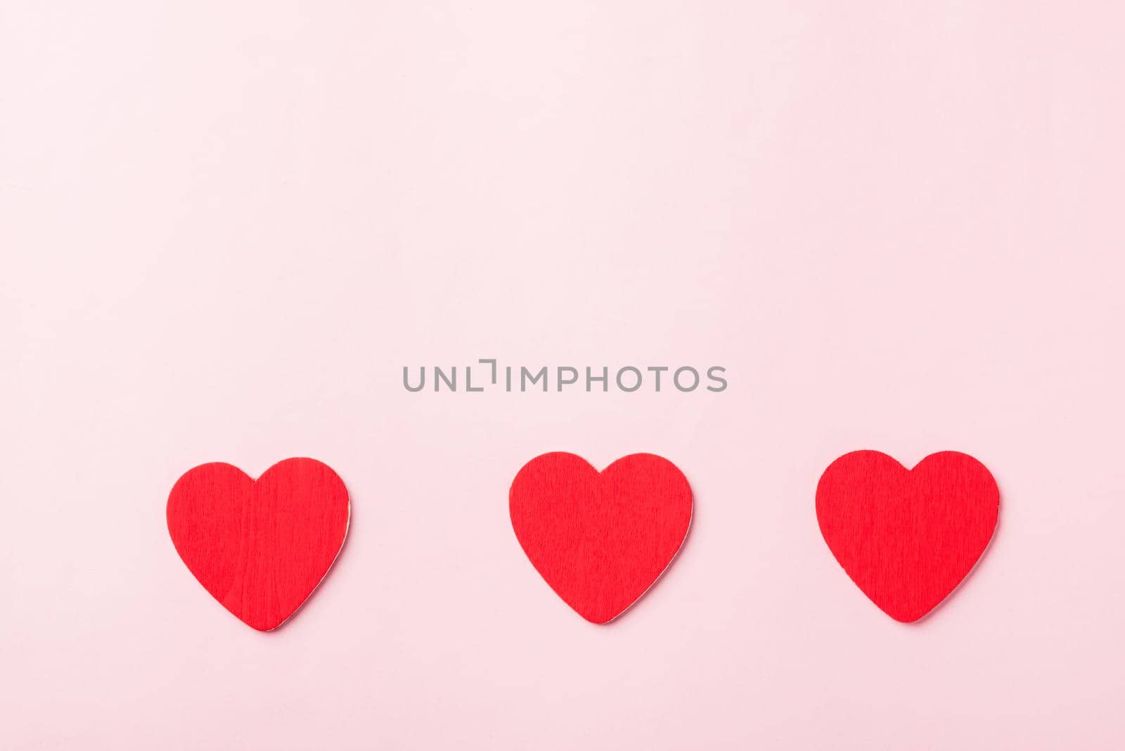 Valentines' day background. red hearts composition greeting card for love Valentines day concept isolated on pink background with copy space. Top View flat lay from above