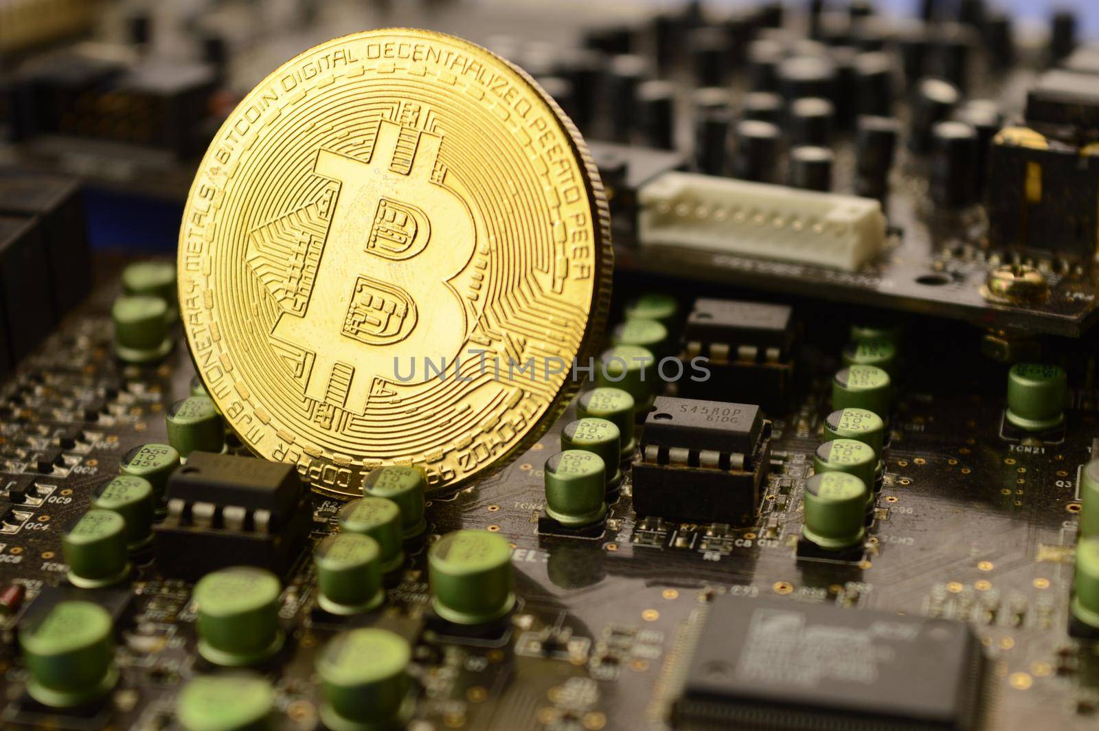 A closeup of a Bitcoin with some computer circuit boards to illustrate the decentralized banking system.