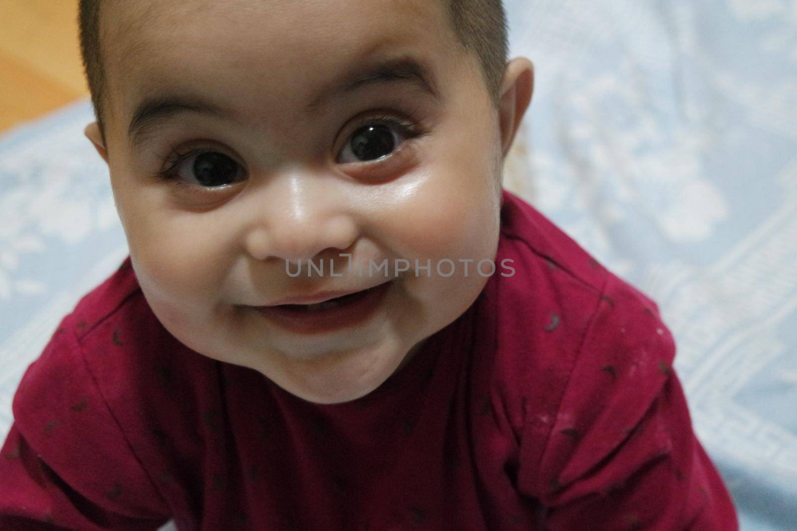 Baby girl with lovely face, big eyes and cute face gesture. Toddler baby making sweet activities