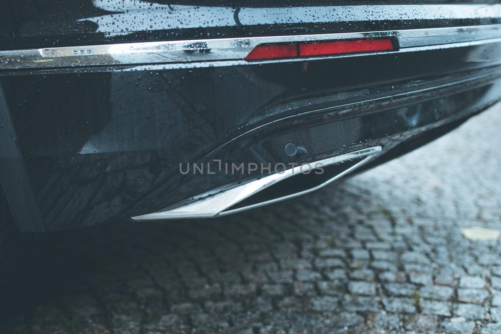 Close up of an exhaust pipe of a car, environmental pollution