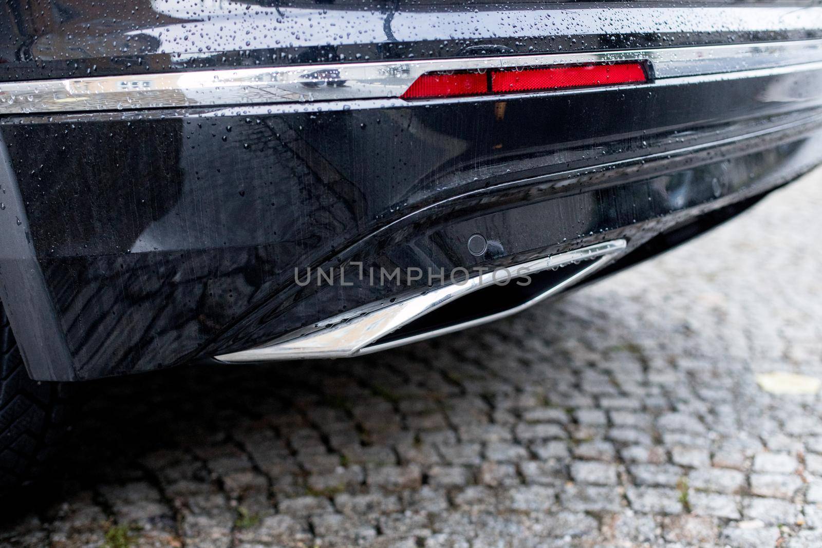 Close up of an exhaust pipe of a car, environmental pollution