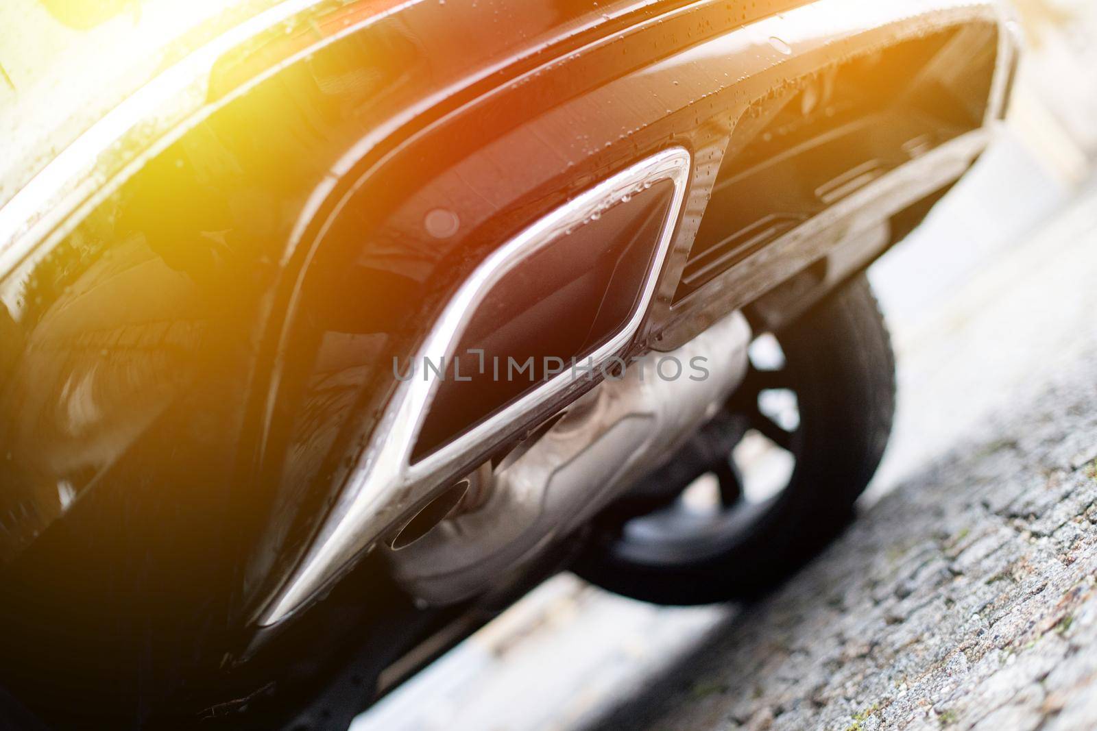 Close up of an exhaust pipe of a car, environmental pollution