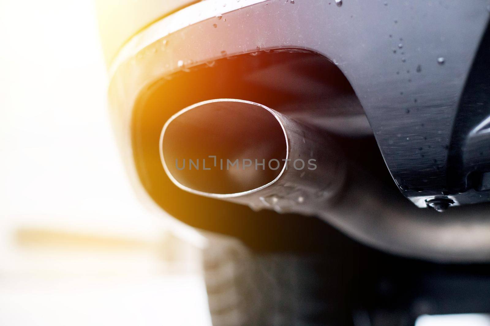 Close up of an exhaust pipe of a car, environmental pollution