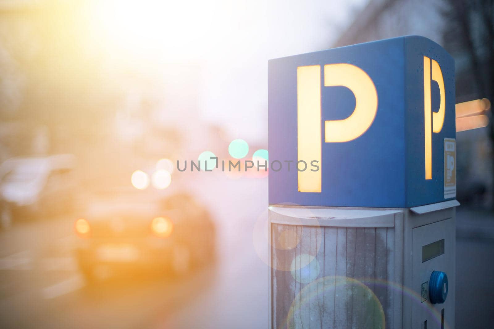 Parking machine in the city street, evening, sunlight.