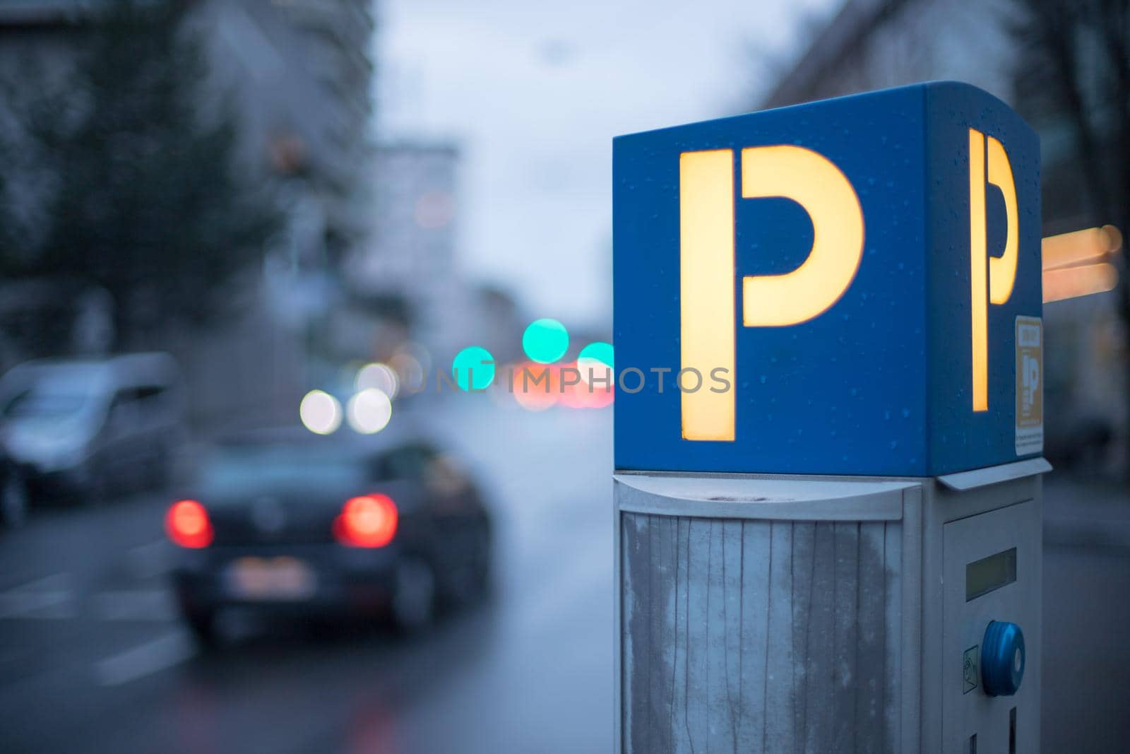 Parking machine in the city street, evening