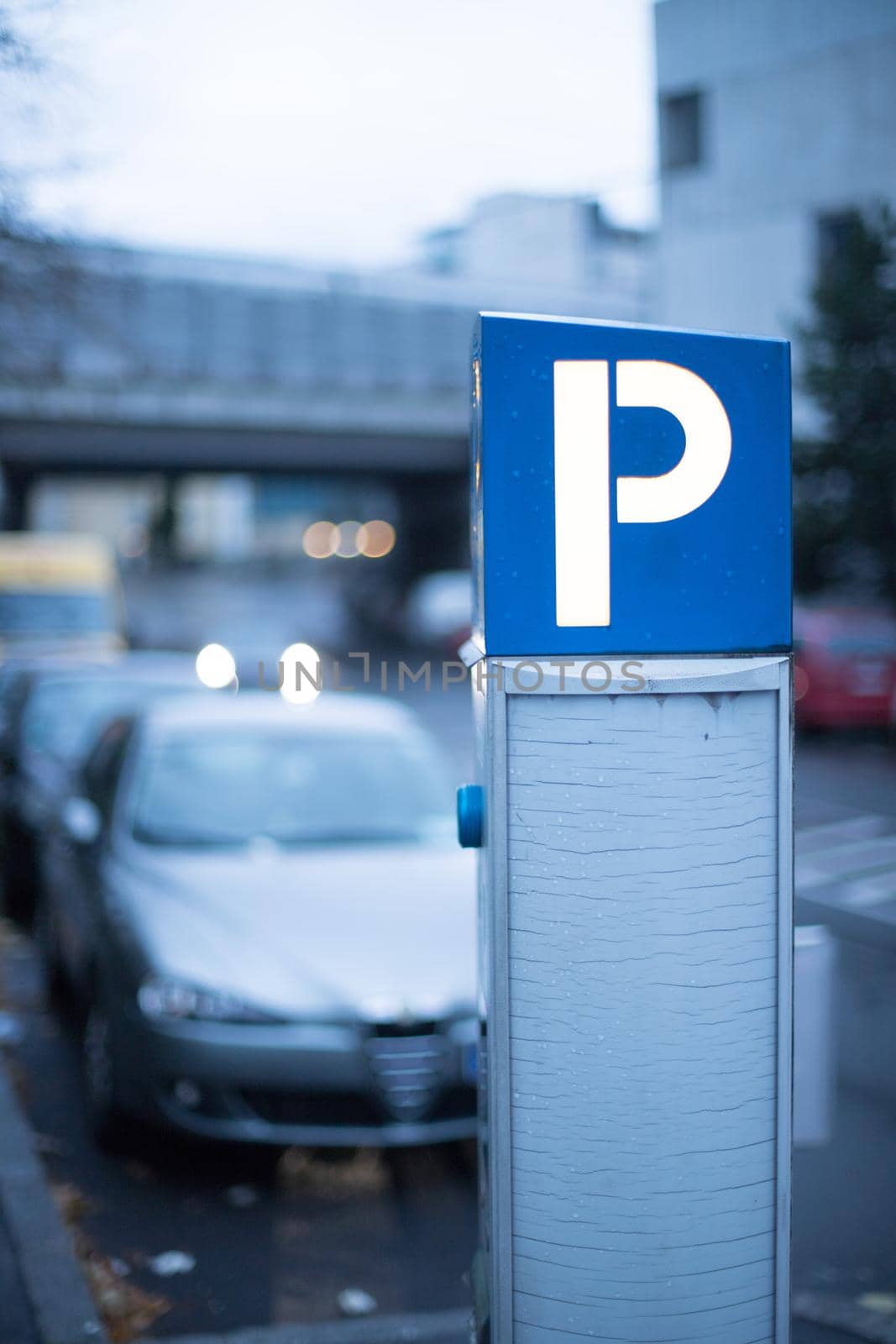 Parking in midtown: parking machine, evening scenery and cars by Daxenbichler