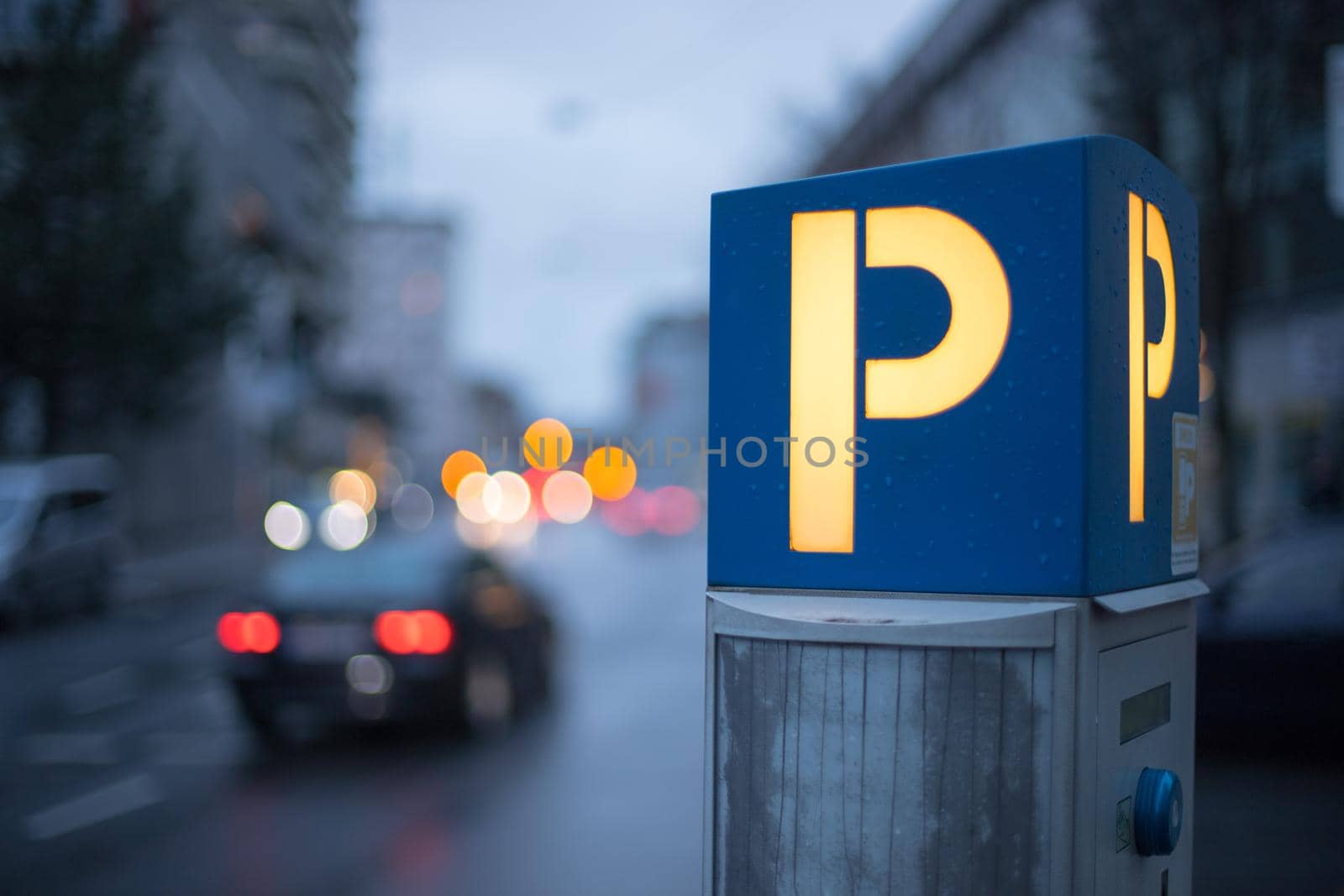 Parking machine in the city street, evening
