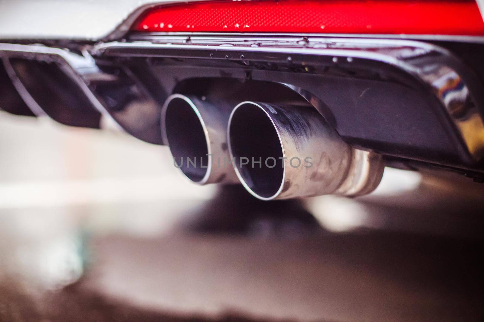 Close up of an exhaust pipe of a car, environmental pollution