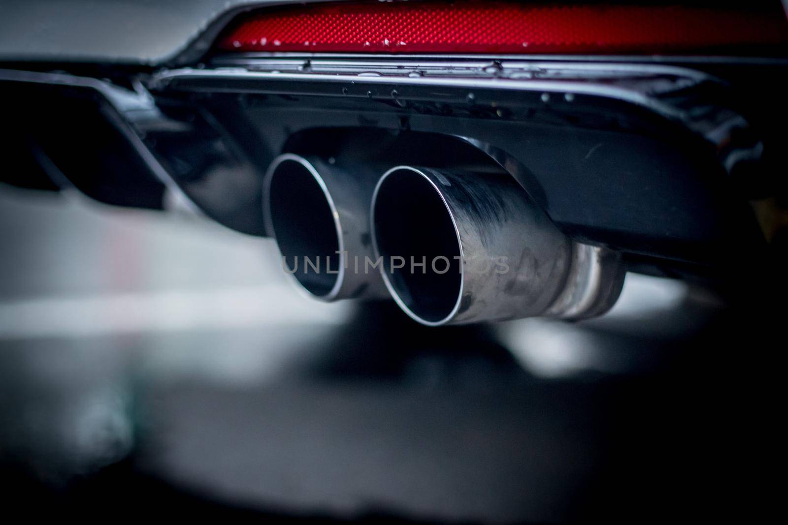Close up of an exhaust pipe of a car, environmental pollution