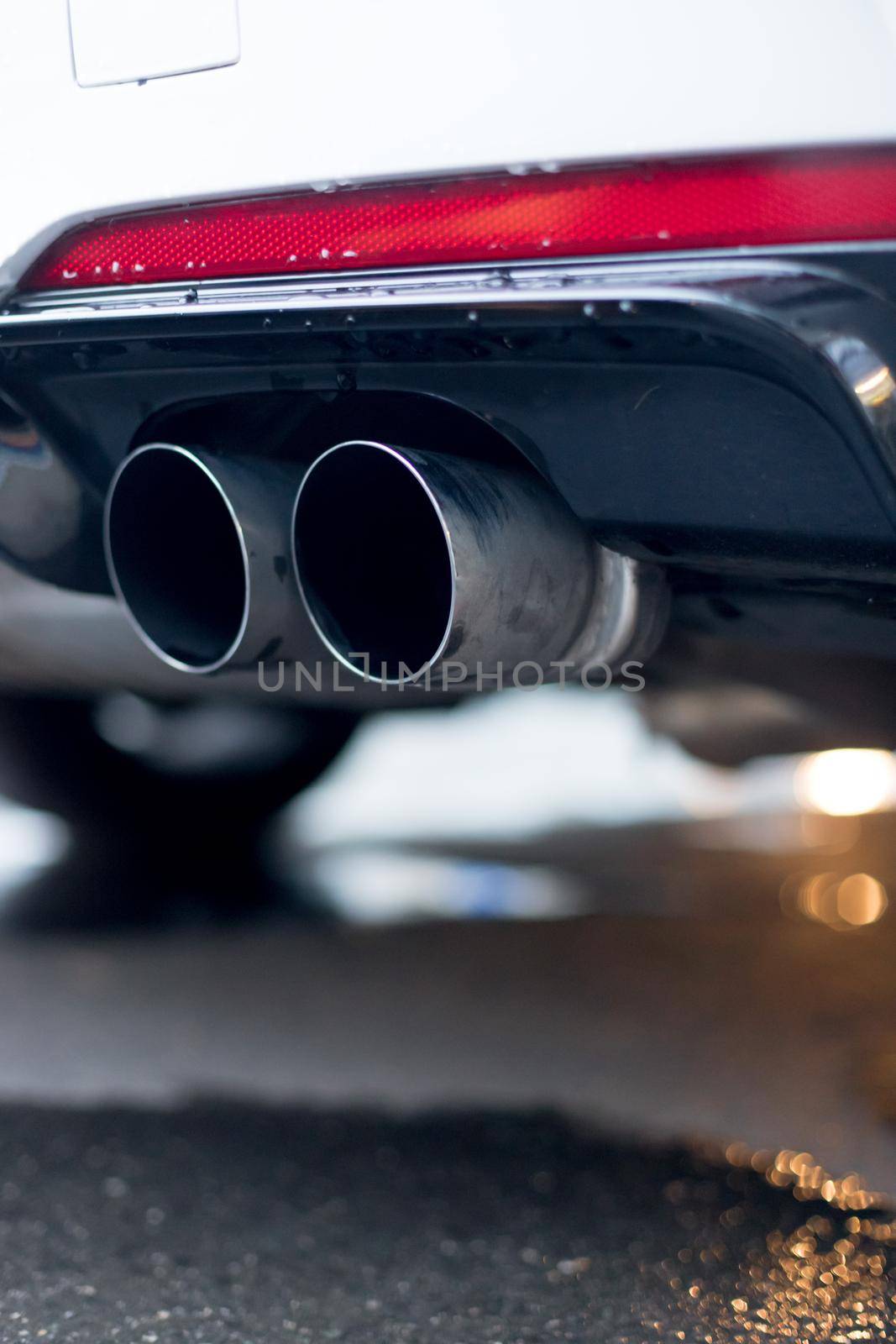 Close up of an exhaust pipe of a car, environmental pollution