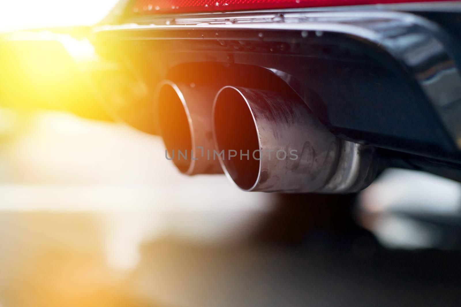 Close up of an exhaust pipe of a car, environmental pollution