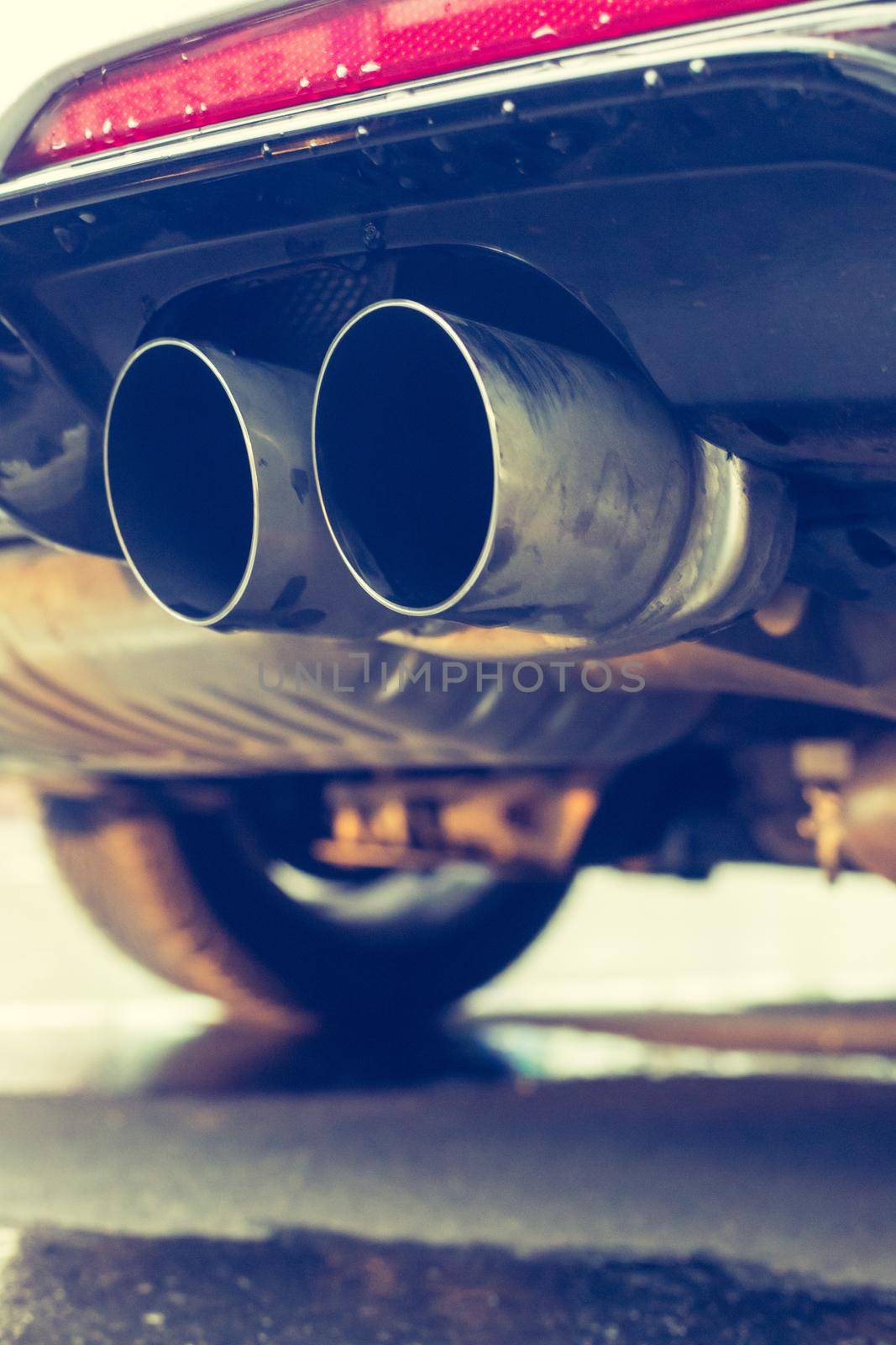 Close up of an exhaust pipe of a car, environmental pollution