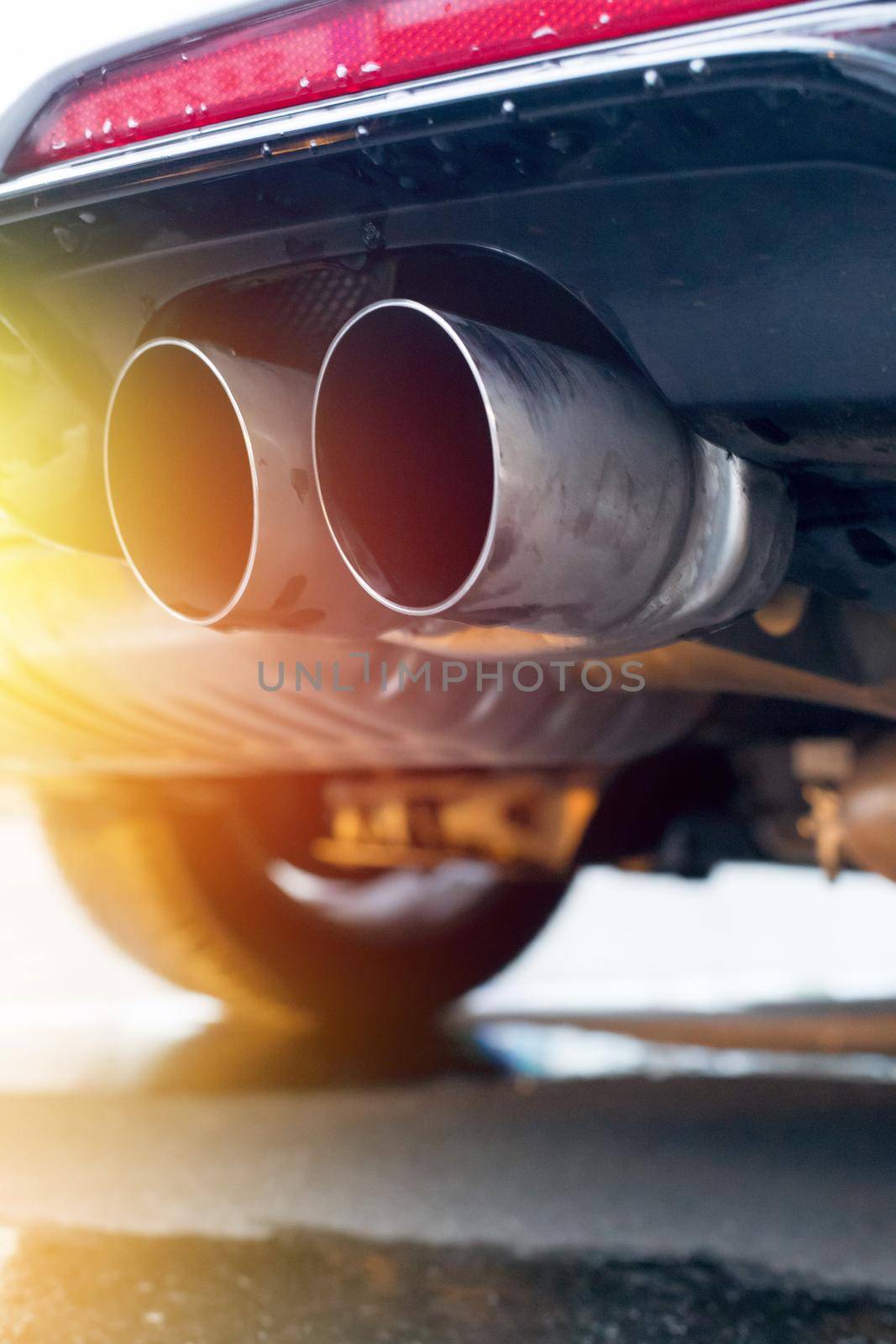 Close up of an exhaust pipe of a car, environmental pollution