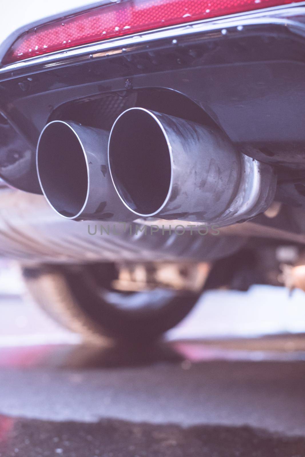 Close up of an exhaust pipe of a car, environmental pollution