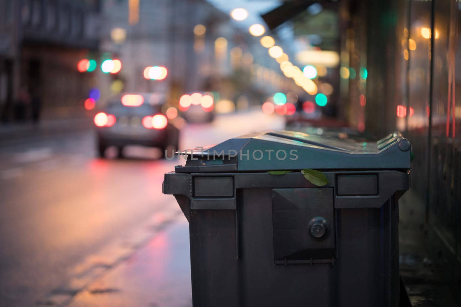 Urban street life with garbage container and street lights