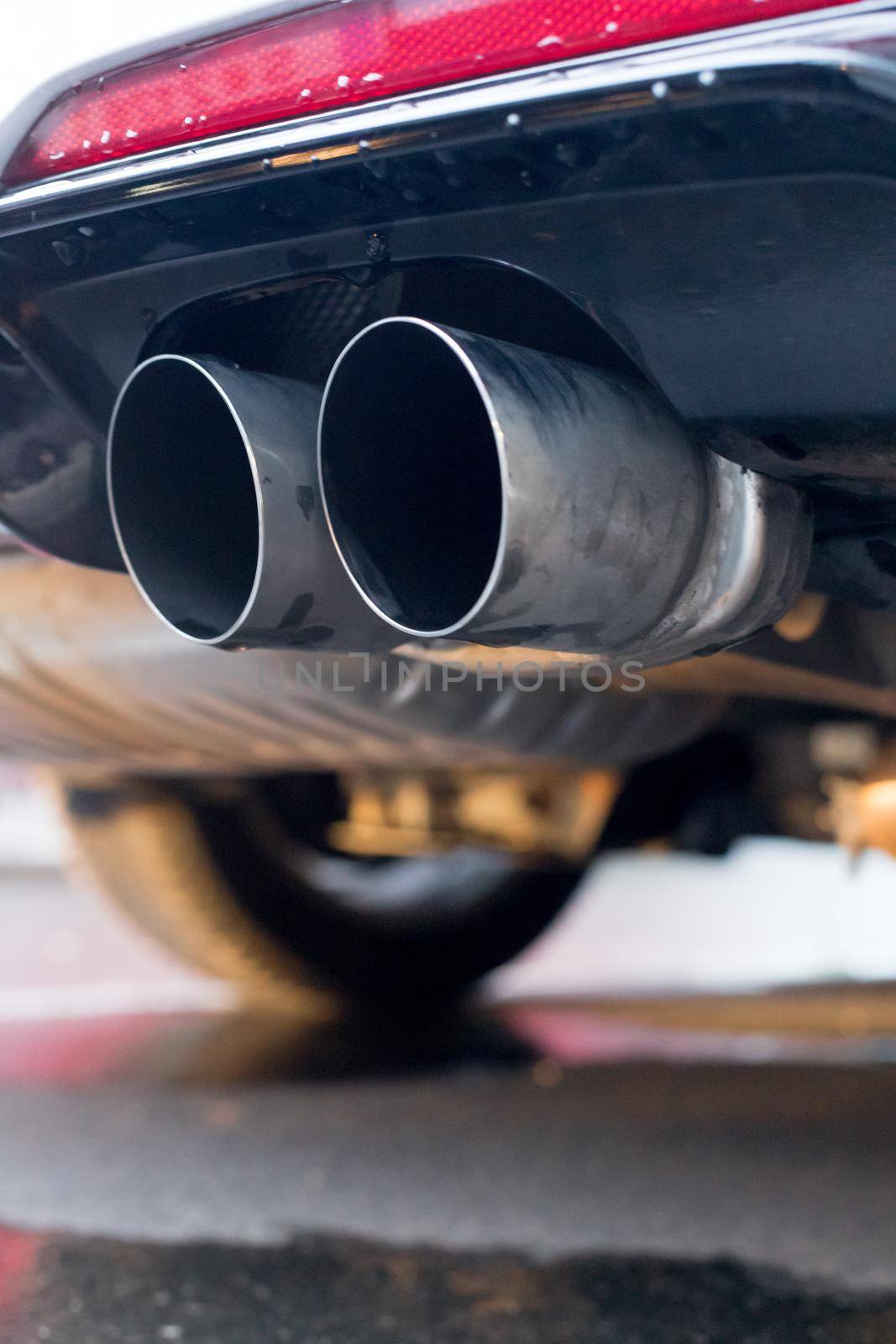 Close up of an exhaust pipe of a car, environmental pollution