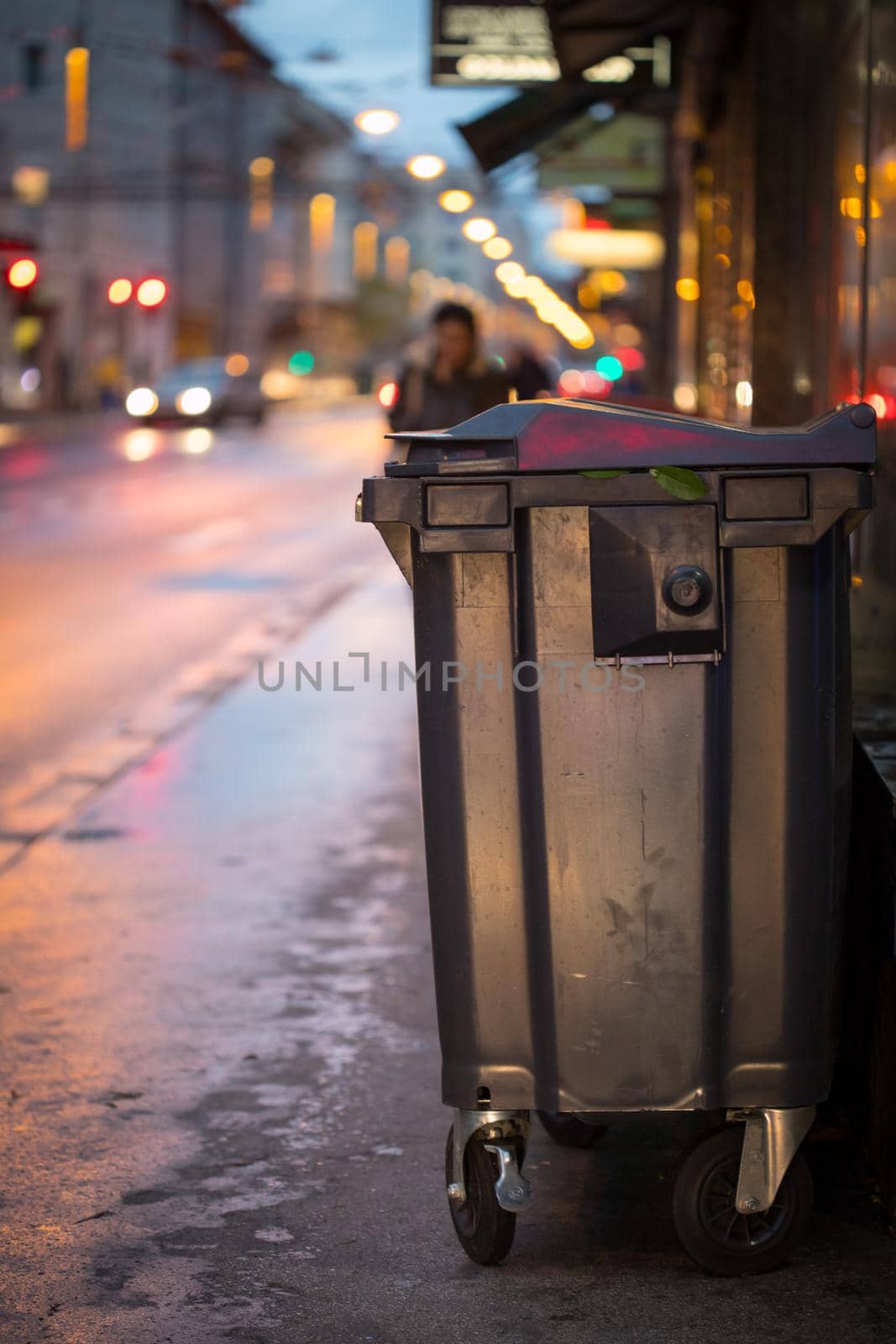 Urban street life with garbage container and street lights
