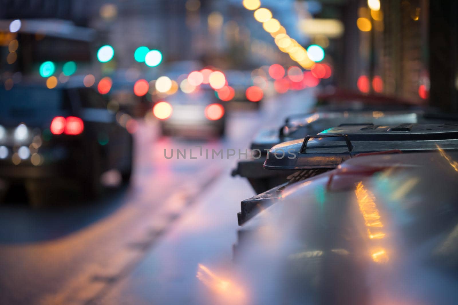 Urban street life with garbage container and street lights