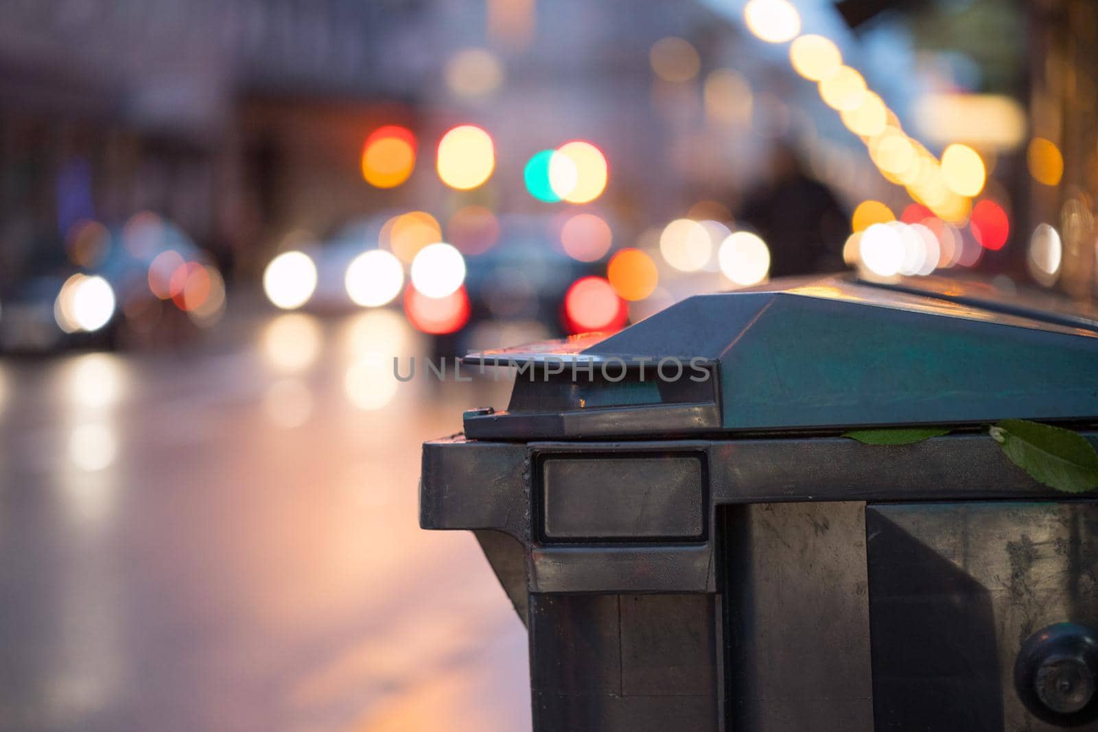 Urban street life with garbage container and street lights