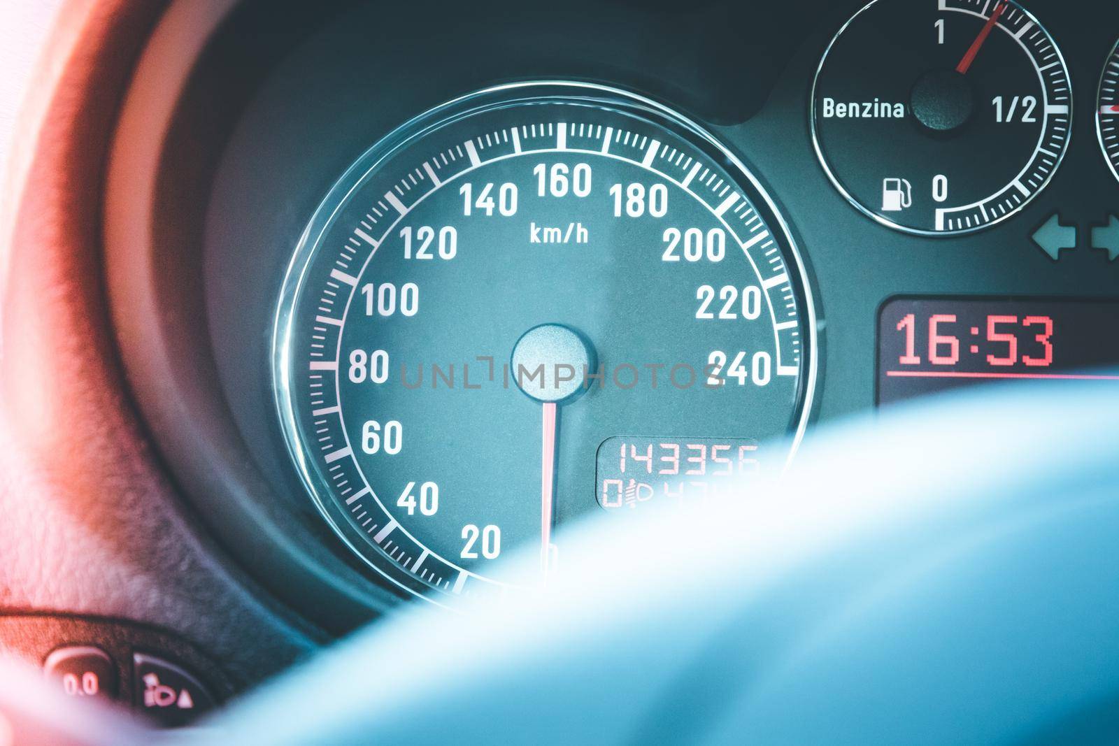 Closeup of the dashboard of a sports car, tachometer and fuel indicator
