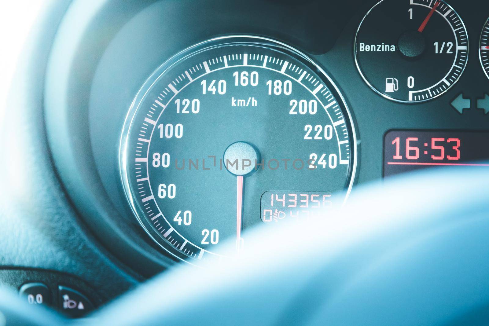Closeup of the dashboard of a sports car, tachometer and fuel indicator