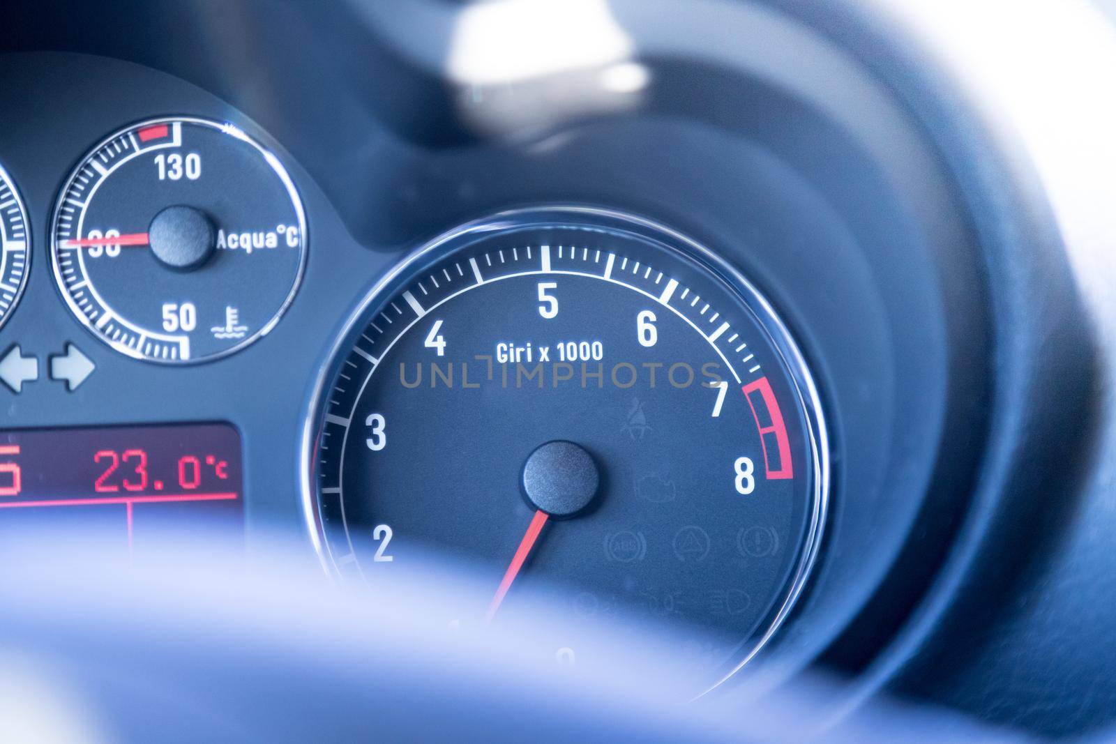 Closeup of the dashboard of a sports car, tachometer and fuel indicator