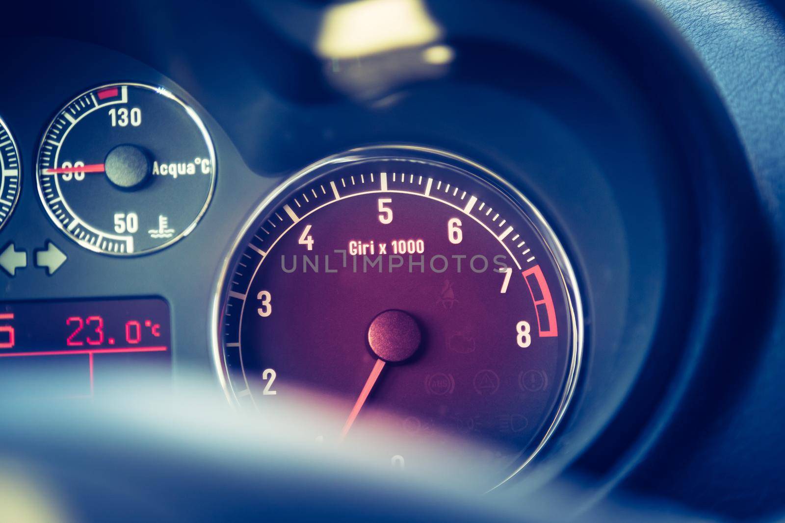 Closeup of the dashboard of a sports car, tachometer and fuel indicator