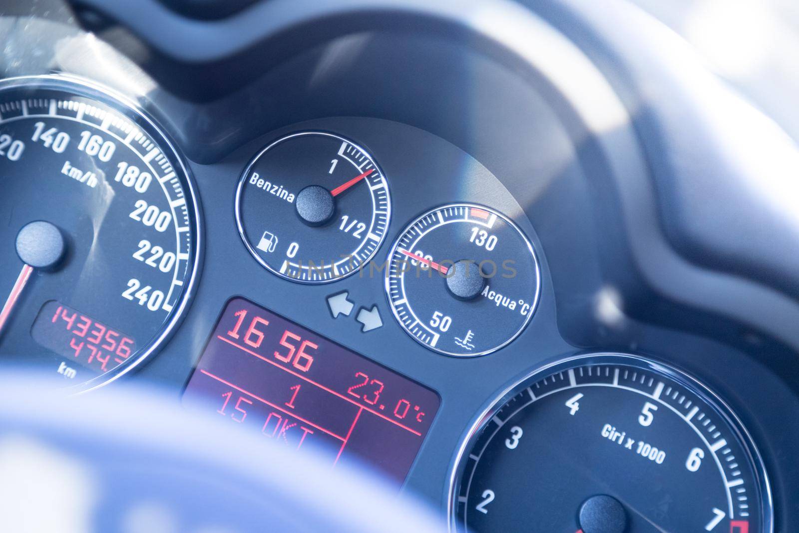 Closeup of the dashboard of a sports car, tachometer and fuel indicator