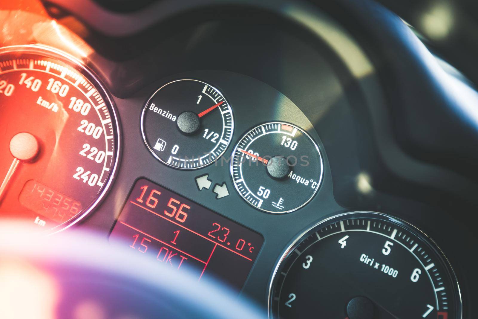 Closeup of the dashboard of a sports car, tachometer and fuel indicator