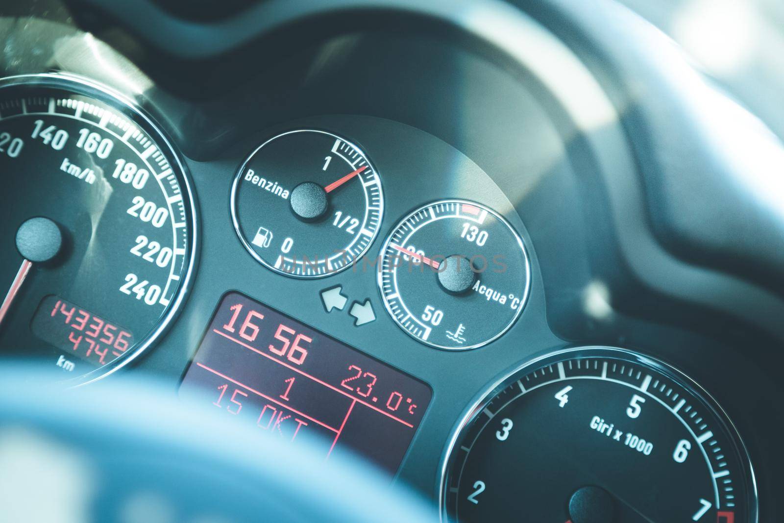 Closeup of the dashboard of a sports car, tachometer and fuel indicator