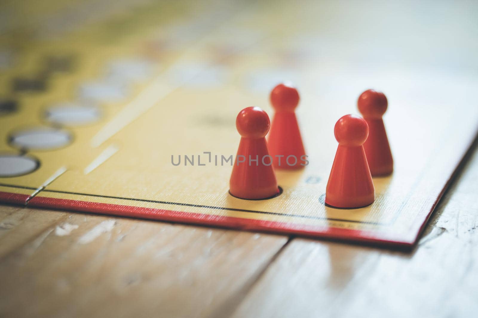Meeples on a board, ready for playing a parlor game, ludo