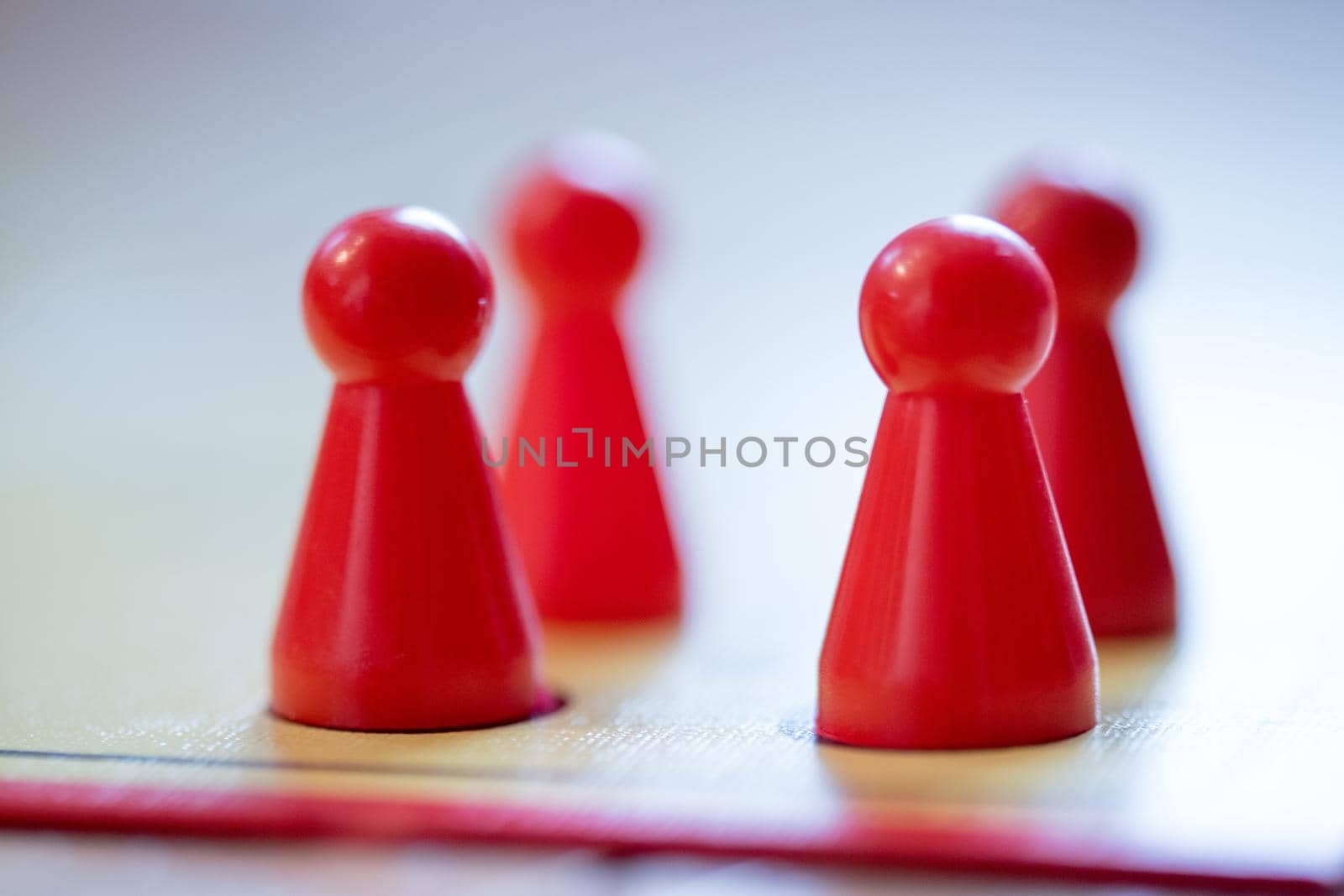 Meeples on a board, ready for playing a parlor game, ludo