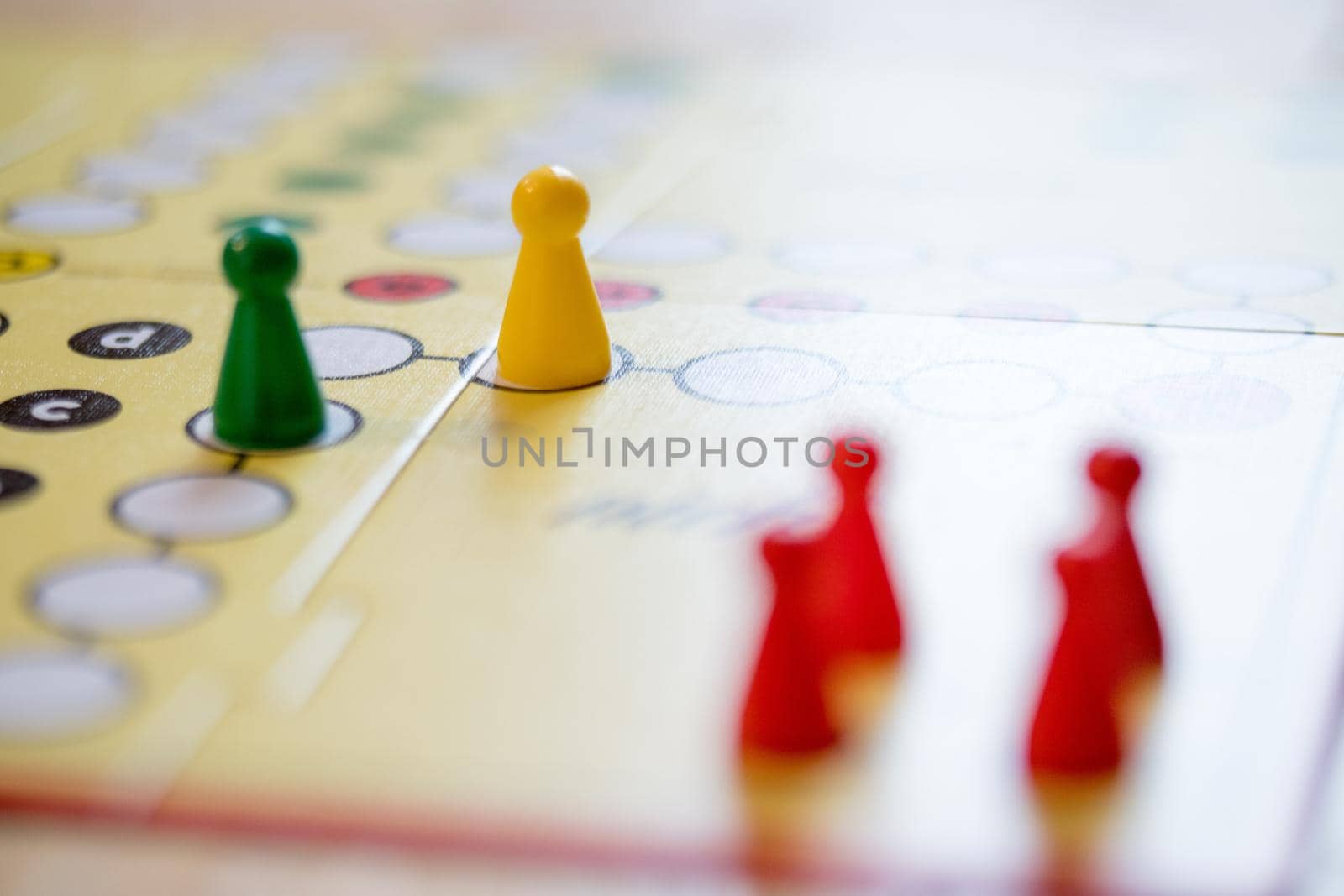 Meeples on a board, ready for playing a parlor game, ludo