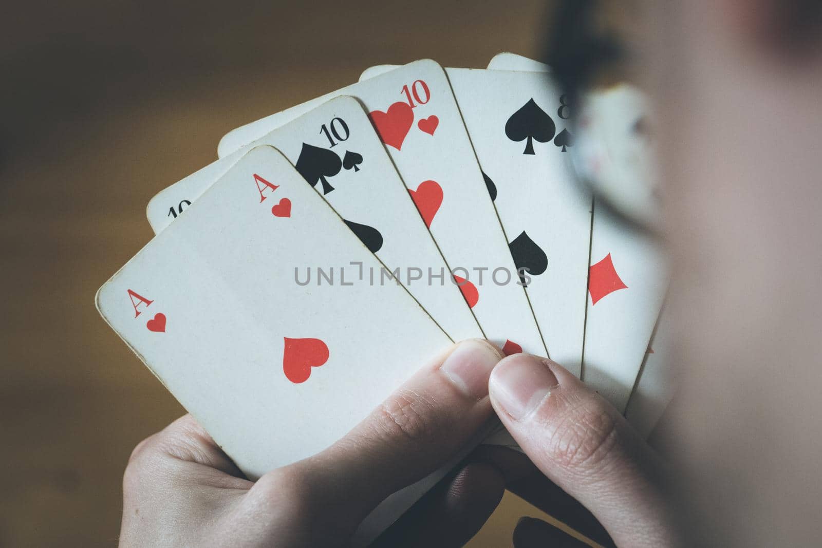 Man is playing cards, cutout of his hands