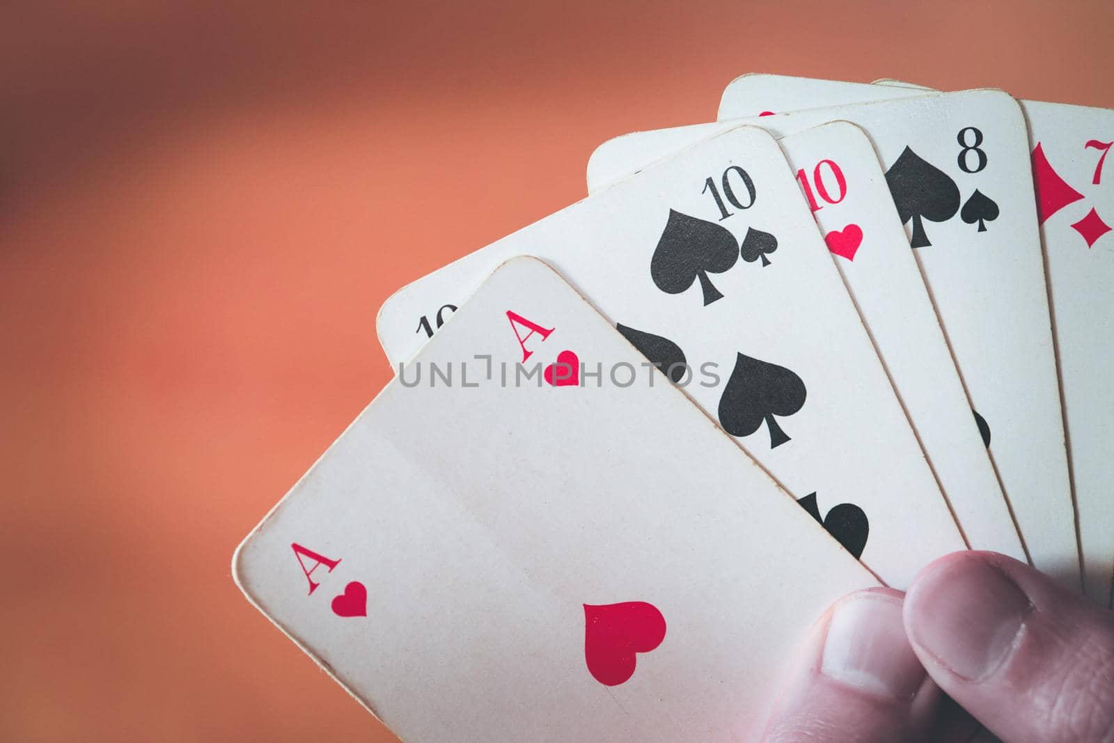 Man is playing cards, cutout of his hands