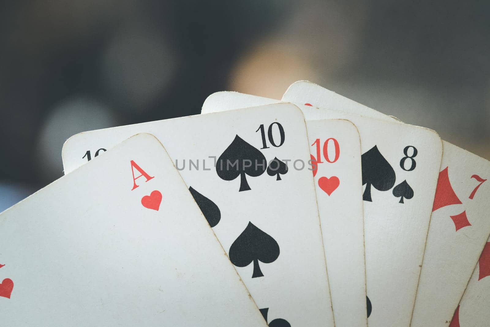 Man is playing cards, cutout of his hands