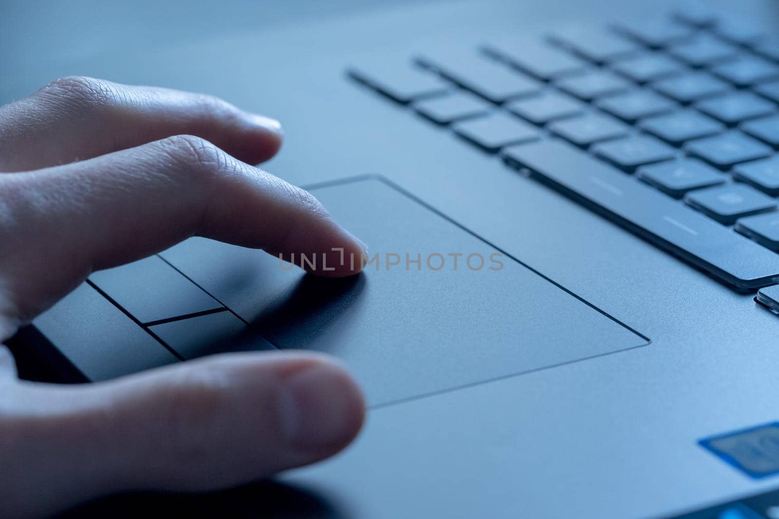 Close up picture of hands using a notebook touchpad