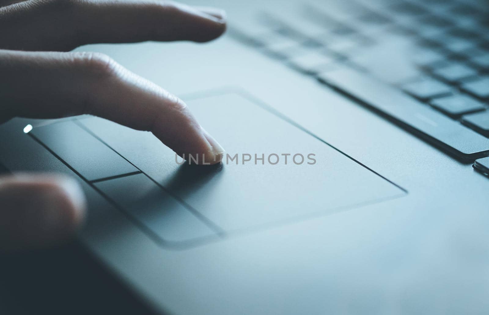 Close up picture of hands using a notebook touchpad