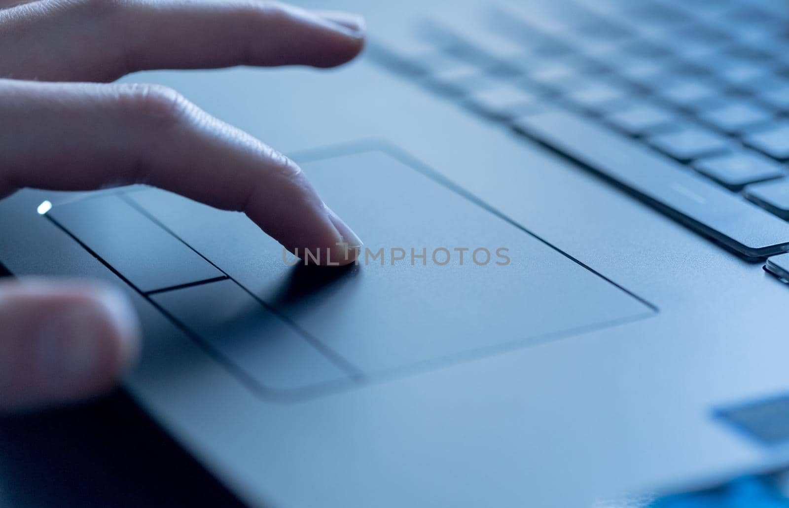 Close up picture of hands using a notebook touchpad