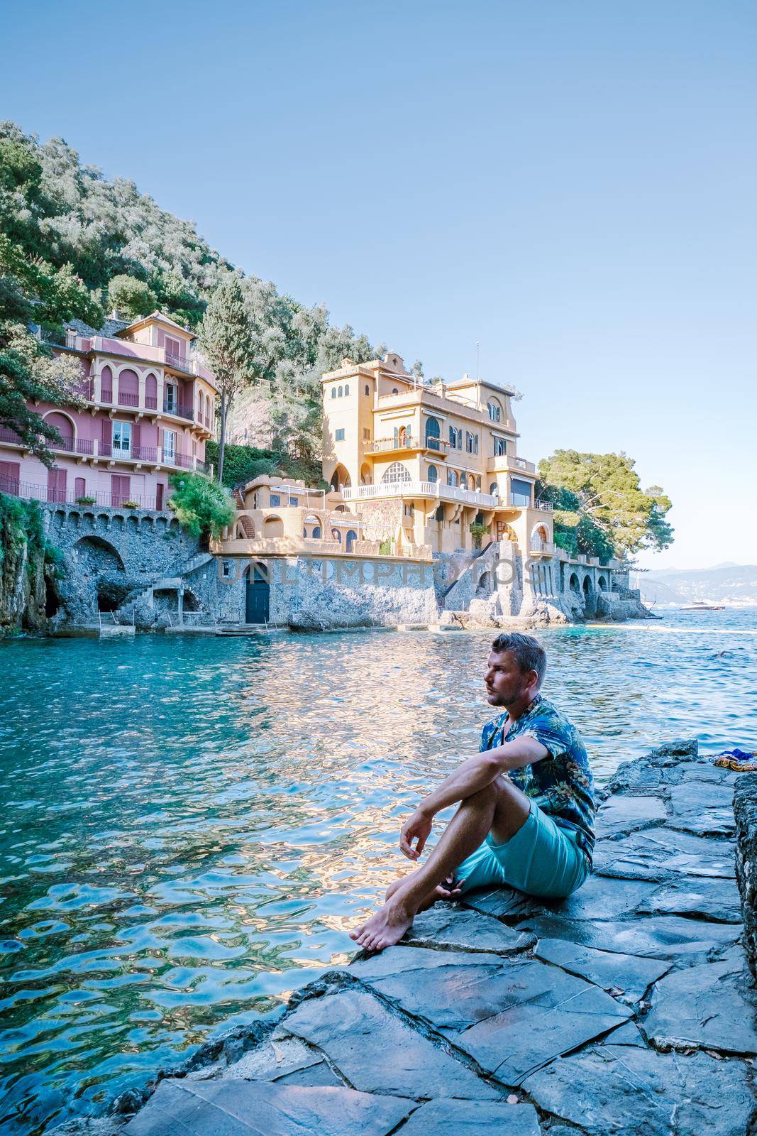 guy on vacation ligurian coast Italy, Portofino famous village bay, Italy colorful village Ligurian coast by fokkebok