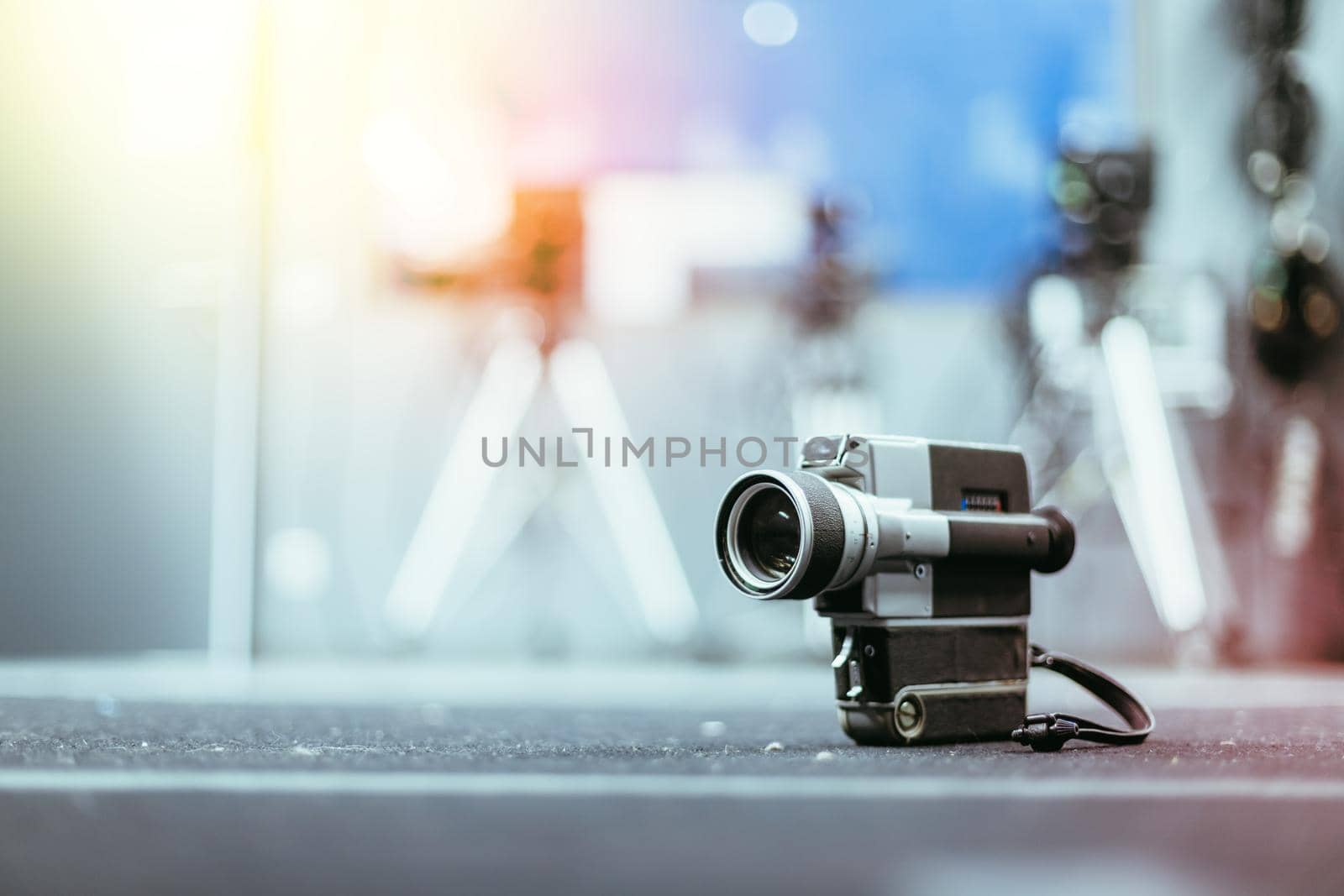 Vintage old movie camera, production studio in the blurry background