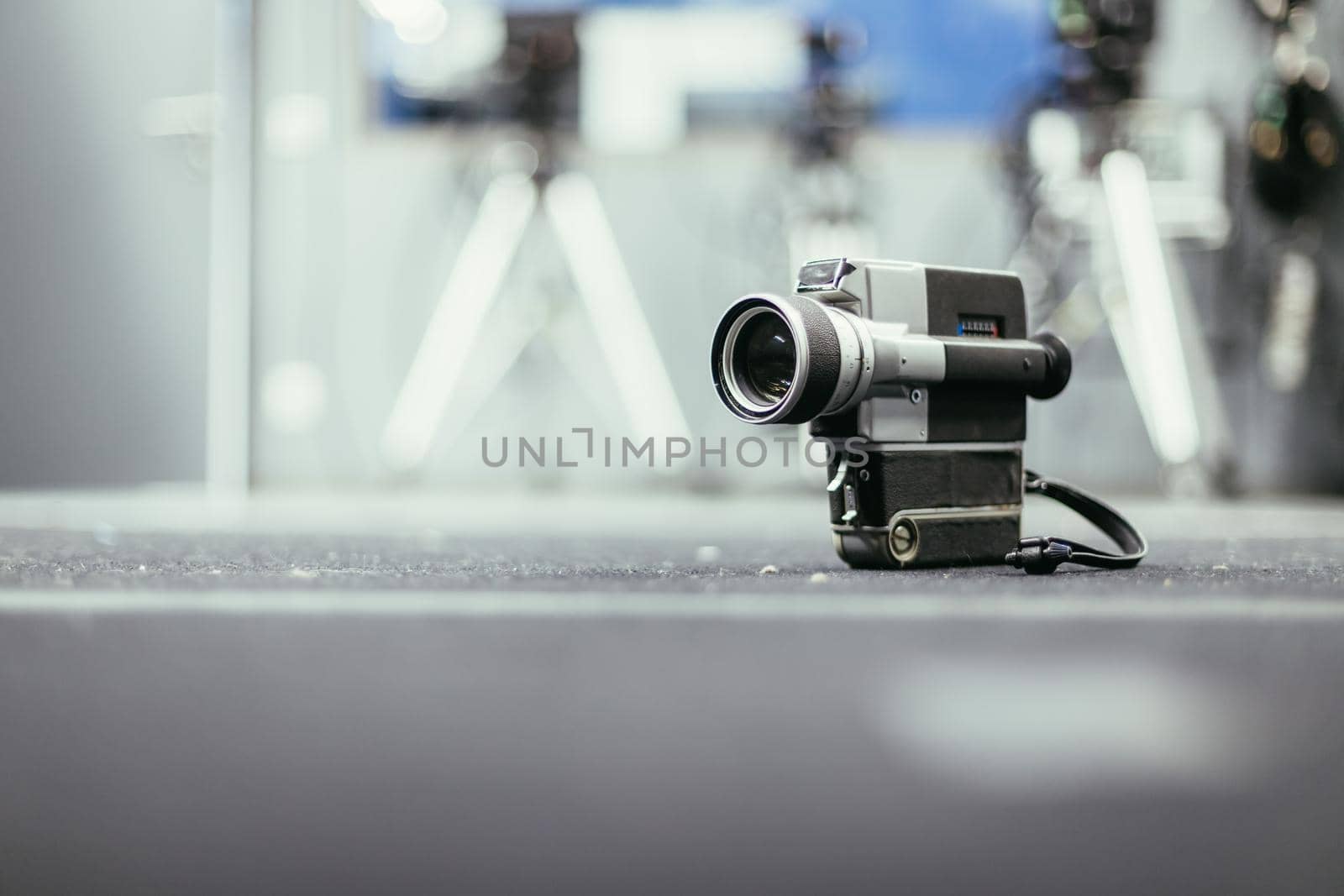 Vintage old movie camera, production studio in the blurry background