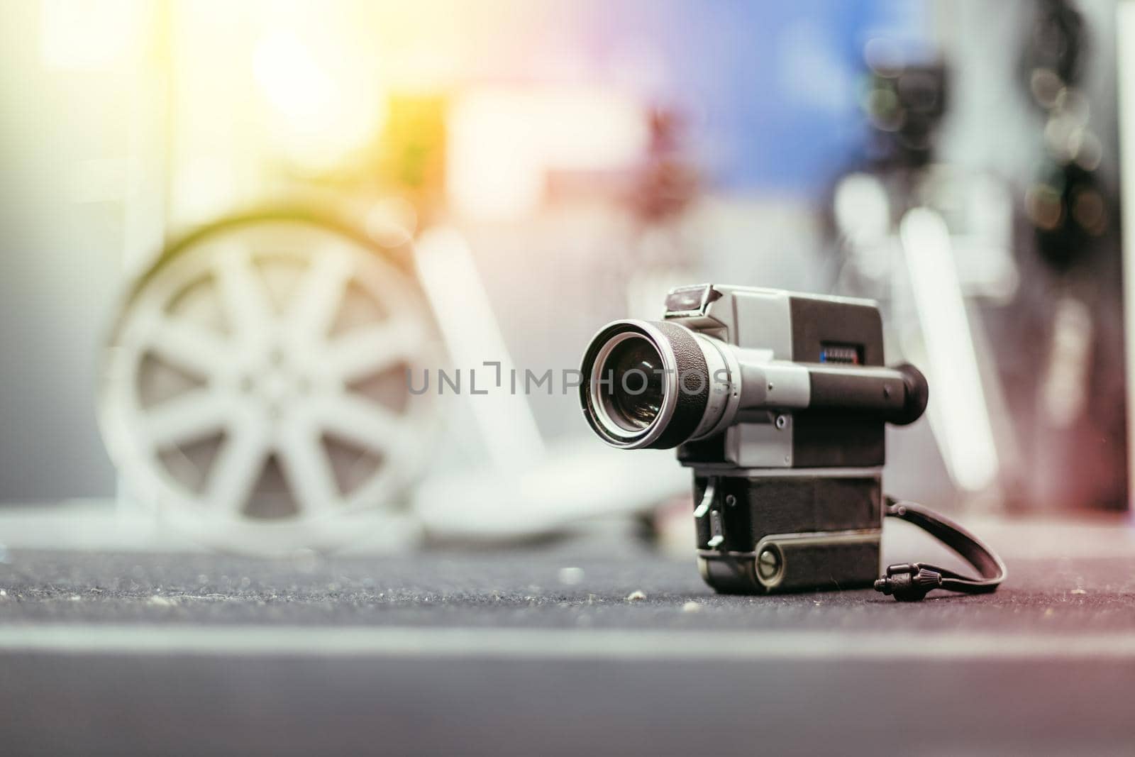 Vintage old movie camera, production studio in the blurry background