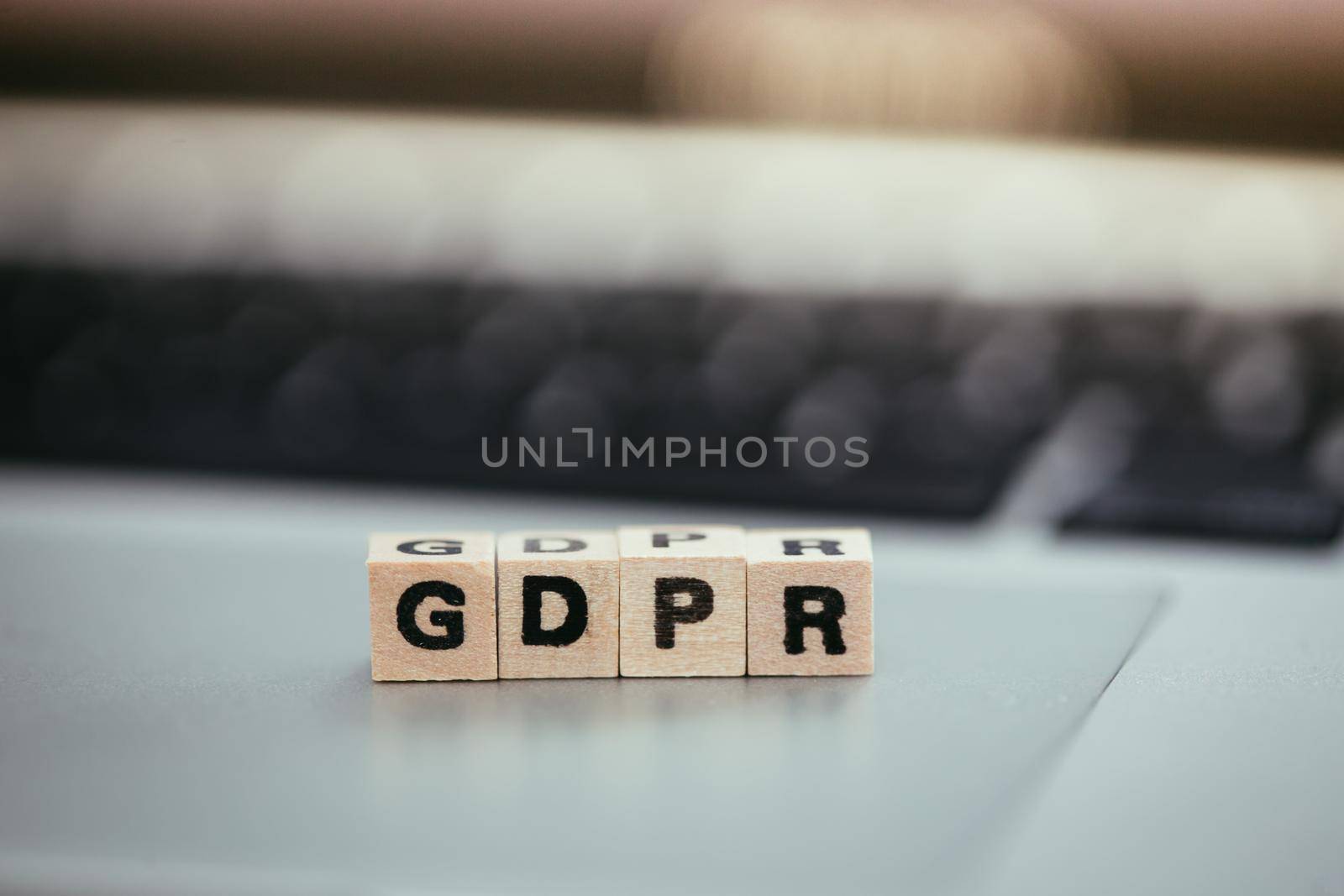 GDPR: Wooden cubes with letters “GDPR” lying on a laptop. General Data Protection Regulation