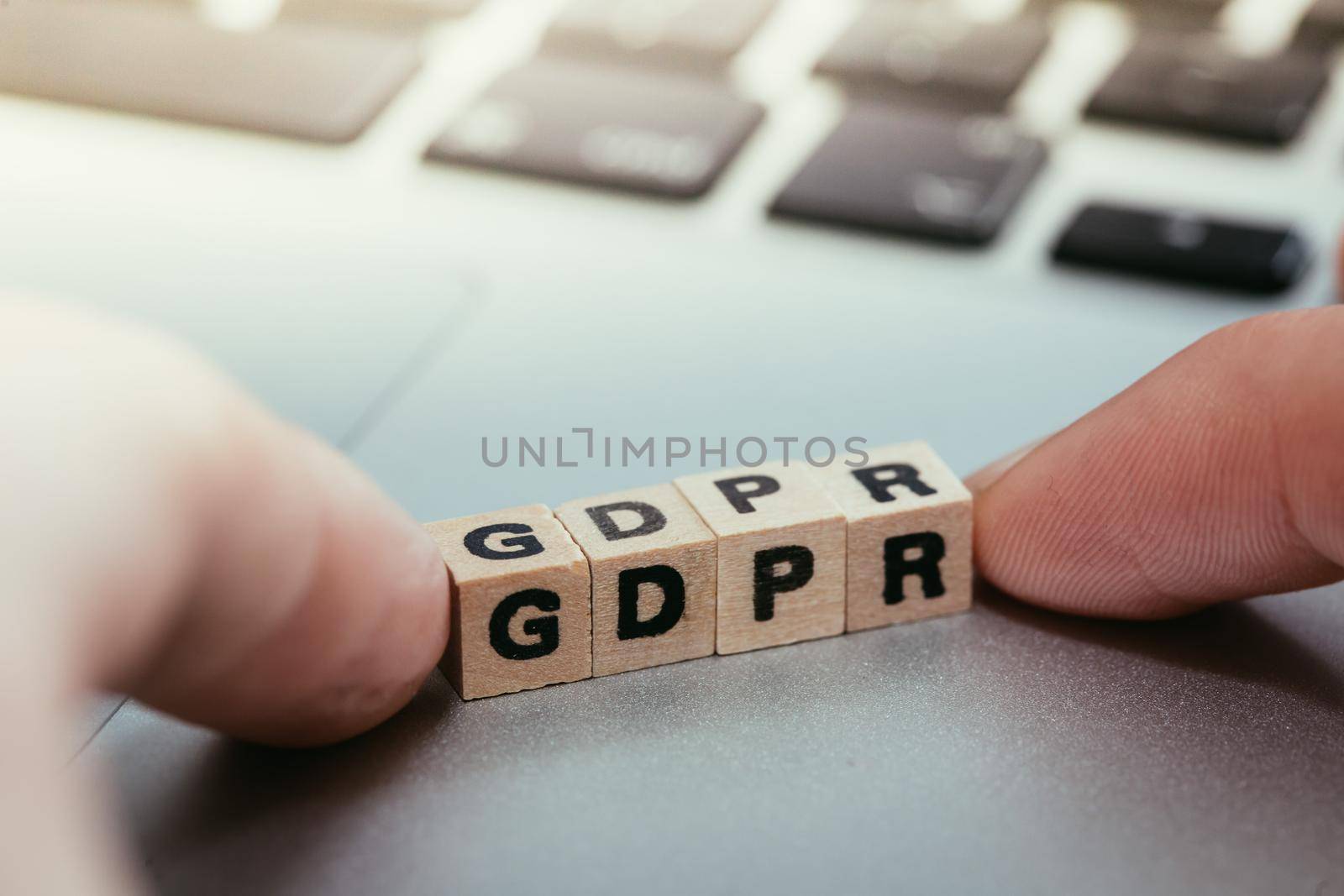 GDPR: Wooden cubes with letters “GDPR” lying on a laptop. General Data Protection Regulation