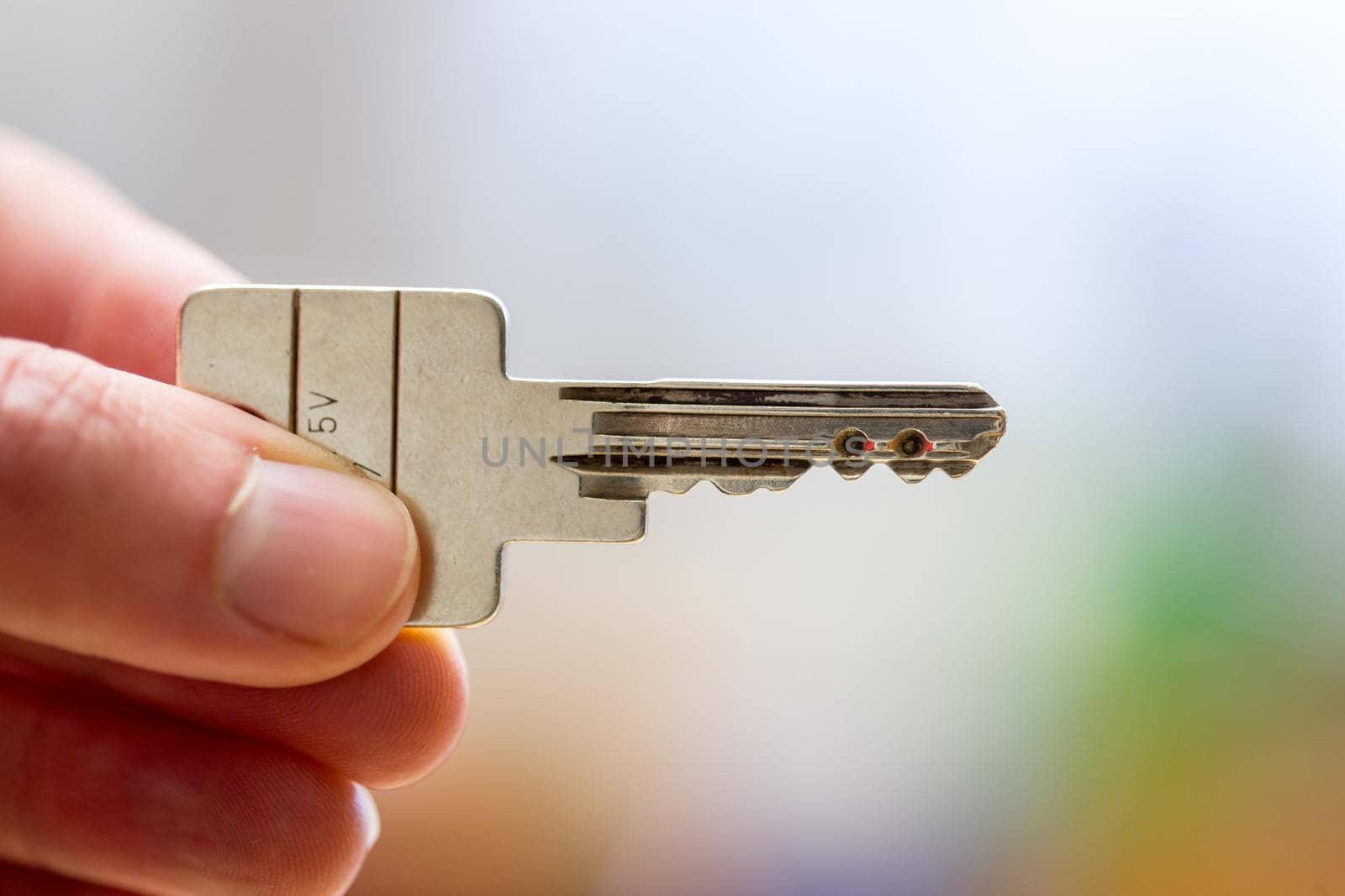 Holding a house key in the hand: New home and property.