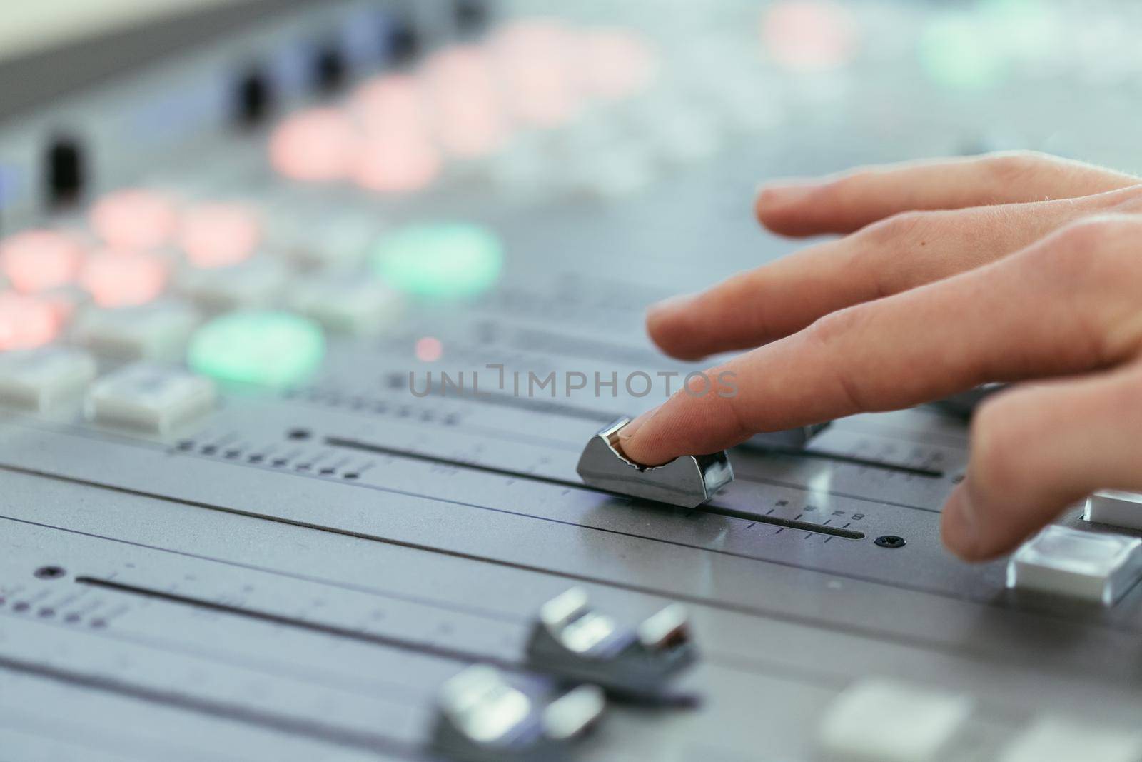 Moderator and soundboard in radio broadcasting studio