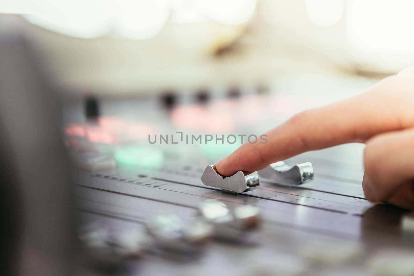Moderator and soundboard in radio broadcasting studio