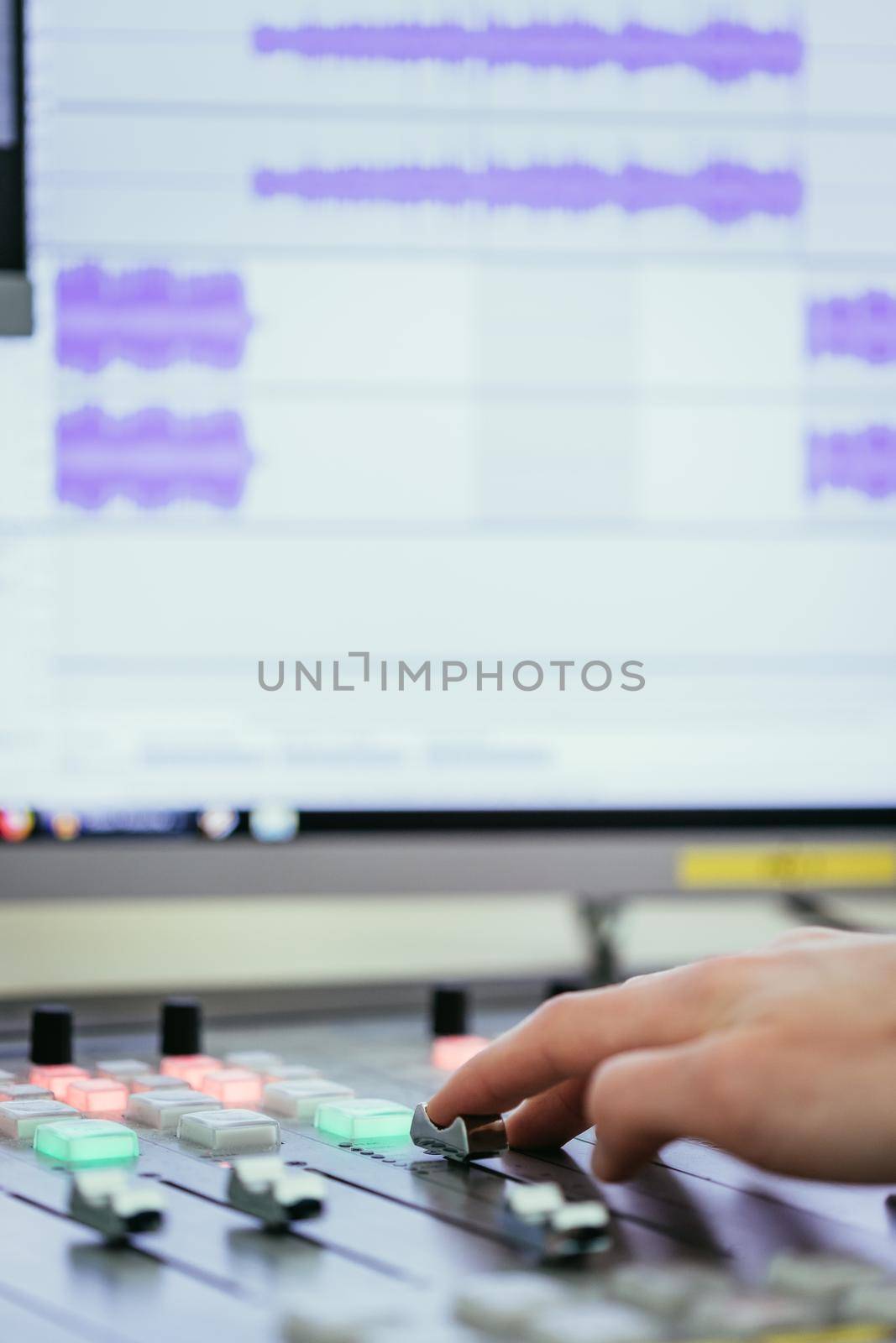 Moderator and soundboard in radio broadcasting studio