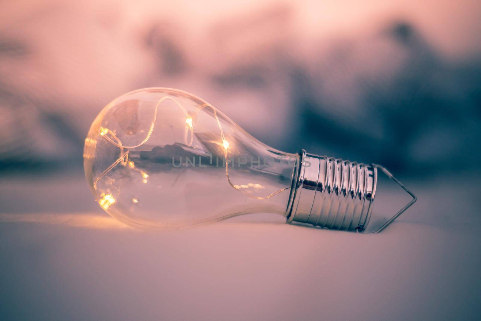 LED light bulb is lying in the bed. Symbol for ideas and innovation.